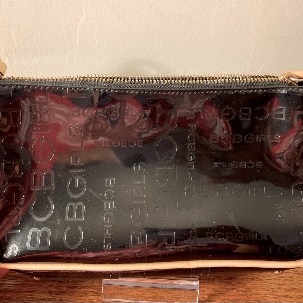 BCBG Black Patent Leather small shoulder bag w/brown leather trim.